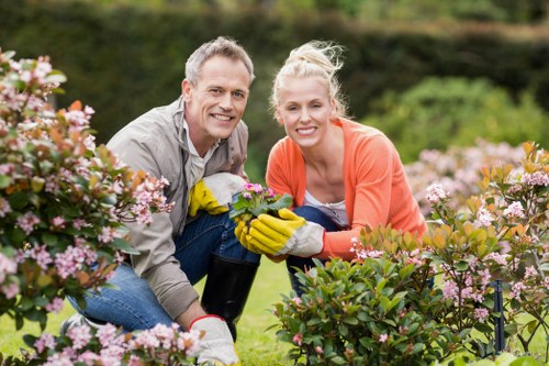 Professional gardener using protective equipment